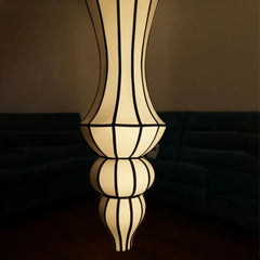 Close look of decorative lamp with a geometric design on a reflective surface against a dark background