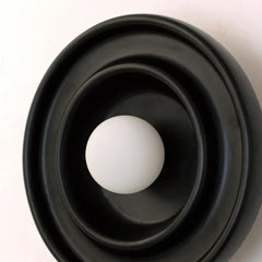 Close-up of Discus Wall Light Black showing the wood grain texture and black finish rim