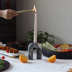 U-shaped candle holder with one white taper candle