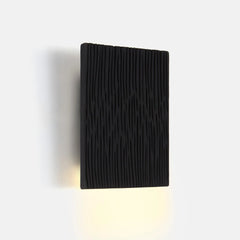 Black ceramic wall light textured surface on a white background
