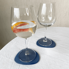 Two Blue Frosted Glass Coasters, placed on a table with two glasses of water.