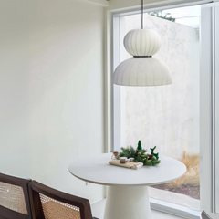 Ivory Cotton Fabric Pendant Light hanging over a small coffee table or seating corner