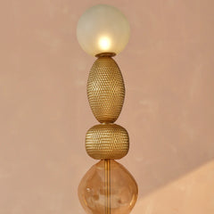 Modern gold floor lamp with gold textured design double-cast glass and frosted sphere