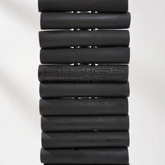 Stack of black cylindrical objects on a white background