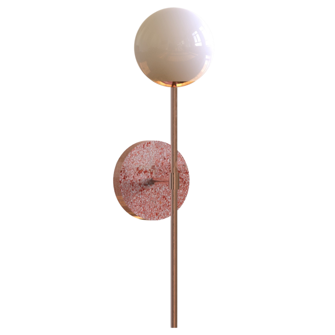 A wall sconce featuring a white glass globe light fixture mounted on a terrazzo base plate.