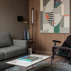 Standing floor lamp with LED strip lighting & black finish in a living room setting