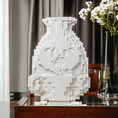 Decorative white flower vase with a pixelated mosaic design.