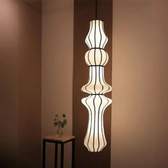 Modern pendant light fixture hanging in a room, refined minimal design with timeless charm