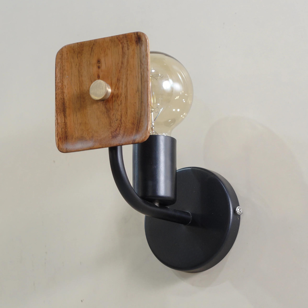 Lodge Wooden Wall Sconce- Wall-mounted light fixture with wooden shade and black arm on white background.
