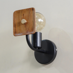 Lodge Wooden Wall Sconce- Wall-mounted light fixture with wooden shade and black arm on white background.