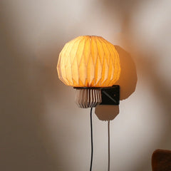Close up of folded linen amber wall lamp shade