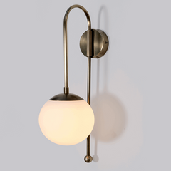 Aged brass wall lamp glass globe mounted up-or-down for feature wall