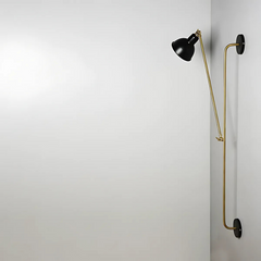 Modern Wall lamp with 2 black fixture and adjustable gold arm on a white wall