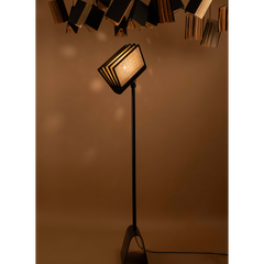 Reeding Floor Lamp full view showing its handwoven cane pages around a metal frame
