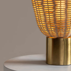 Decorative Meiji Table Lamp with cane woven design and gold base on a neutral background