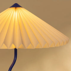 Wavy Floor Lamp - Cobalt Blue close view switched on showing warm ambient glow
