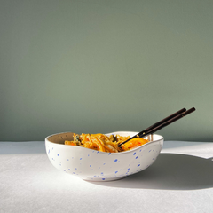 A round Speckled Ceramic bowl with white and blue speckles.