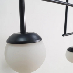 Close look of minimalist Chandelier with frosted glass shade.