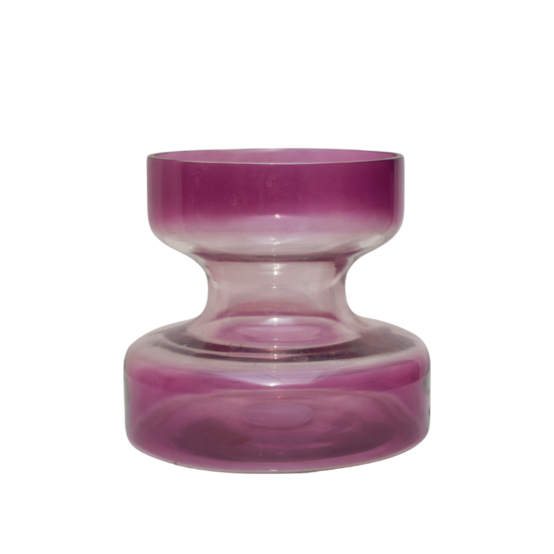 A tall lilac colored glass vase with a retro shape, displayed with a smaller vase of the same color in the background, both containing pink flowers.