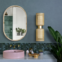Metamorphosis Wall Lamp installed beside mirror in bathroom or vanity, ambient mood lighting.