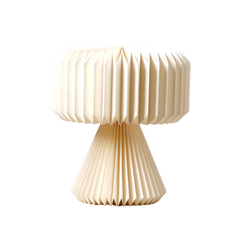A white origami paper table lamp with a pleated design, representing the Orilamp product by Fig Living.