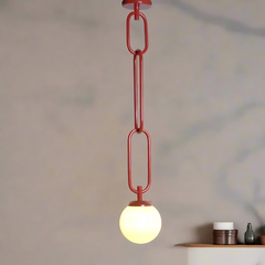 Chain link red ceiling light fixture in the shape of interconnected torus links with a white glass diffuser at the bottom.