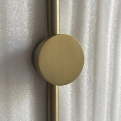 Lune Rise Alabaster Wall Light with gold brass accents on a textured white background