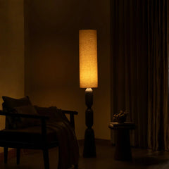Modern Orin Floor Lamp casting a warm glow in a dark room