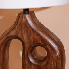Close-up of a designer wooden table lamp base with a beige background
