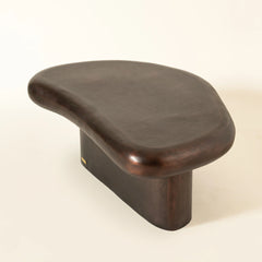 Wooden coffee stool with a curved design on a beige background