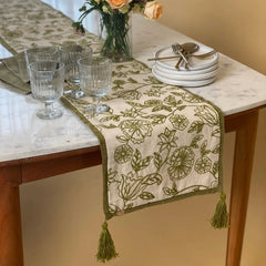 Rosabelle Chintz Olive Table Runner on marble dining table with glassware and plates