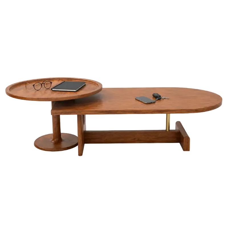 A mid-century modern wooden coffee table with a sliding oval tray top, a lower shelf, and brass support legs, shown on a plain white background with small desk accessories placed on the surfaces.