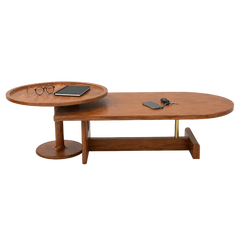 A mid-century modern wooden coffee table with a sliding oval tray top, a lower shelf, and brass support legs, shown on a plain white background with small desk accessories placed on the surfaces.