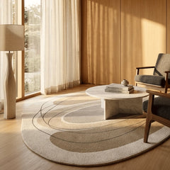 Modern living room with a round rug, coffee table, and chair.