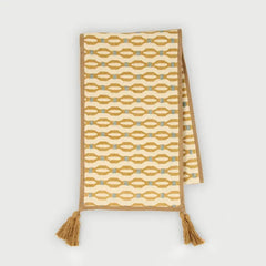 Poppy Ochre Table Runner laid flat, embroidered pattern with microvelvet border and tassels