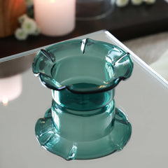 PETAL - Mini Glass Server in teal – translucent petal-rim glass bowl and its reflection on a mirror