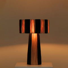 Wald Table lamp with black and natural raffia striped shade, warm ambient light