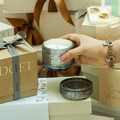 Illume - Candle Gift Set - Smoke & Ivory - Night Jasmine - Set of 2, hand holding smoke glass trinket jar among Doft gift boxes