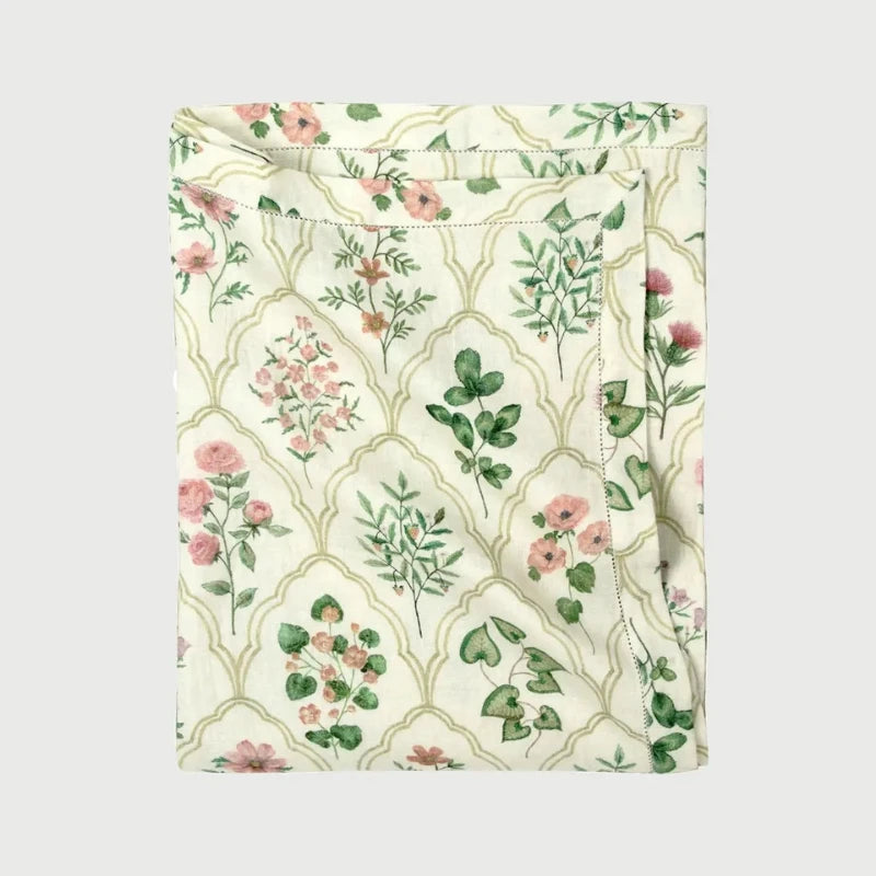Eden Rose Linen Table Cover folded, showing hand-painted floral ogee print