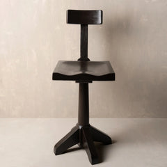 A dark wood bar stool with a unique wingback seat, a backrest, and a four-star base.