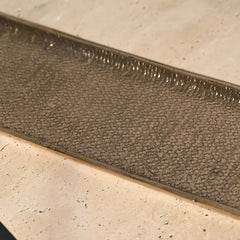 Textured bronze long irregular finished dosa tray on a light stone surface