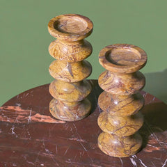 Set of 2 Brown Marble candle holders on a red marble coffee table