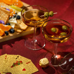 Two Ratri Coupe Glasses & playing cards and snacks.