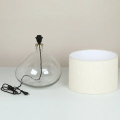 Midora Table Lamp, clear glass body with black cord and white fabric shade