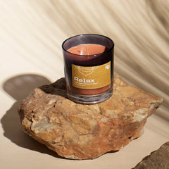 "Relax" Apple & Cinnamon Vegan Wax Scented Candle placed on a stone