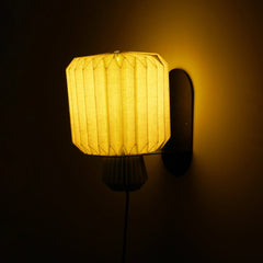 Designer Lumi Fold wall sconce with linen shade soft ambient lighting and braided textile cable