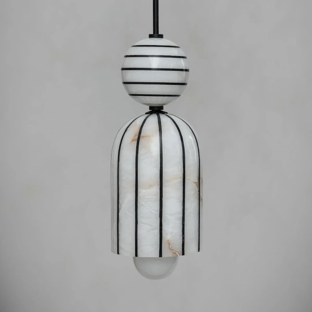 Modern pendant light with black and white striped design on a gray background