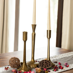 Three brass plated Sanee Candle Holders with a solid pattern, featuring a vertical cylindrical shape for all three