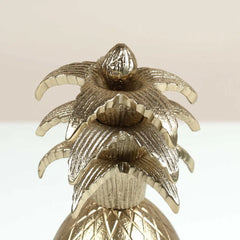 Close view of Gold pineapple shape decorative Votive on a light background