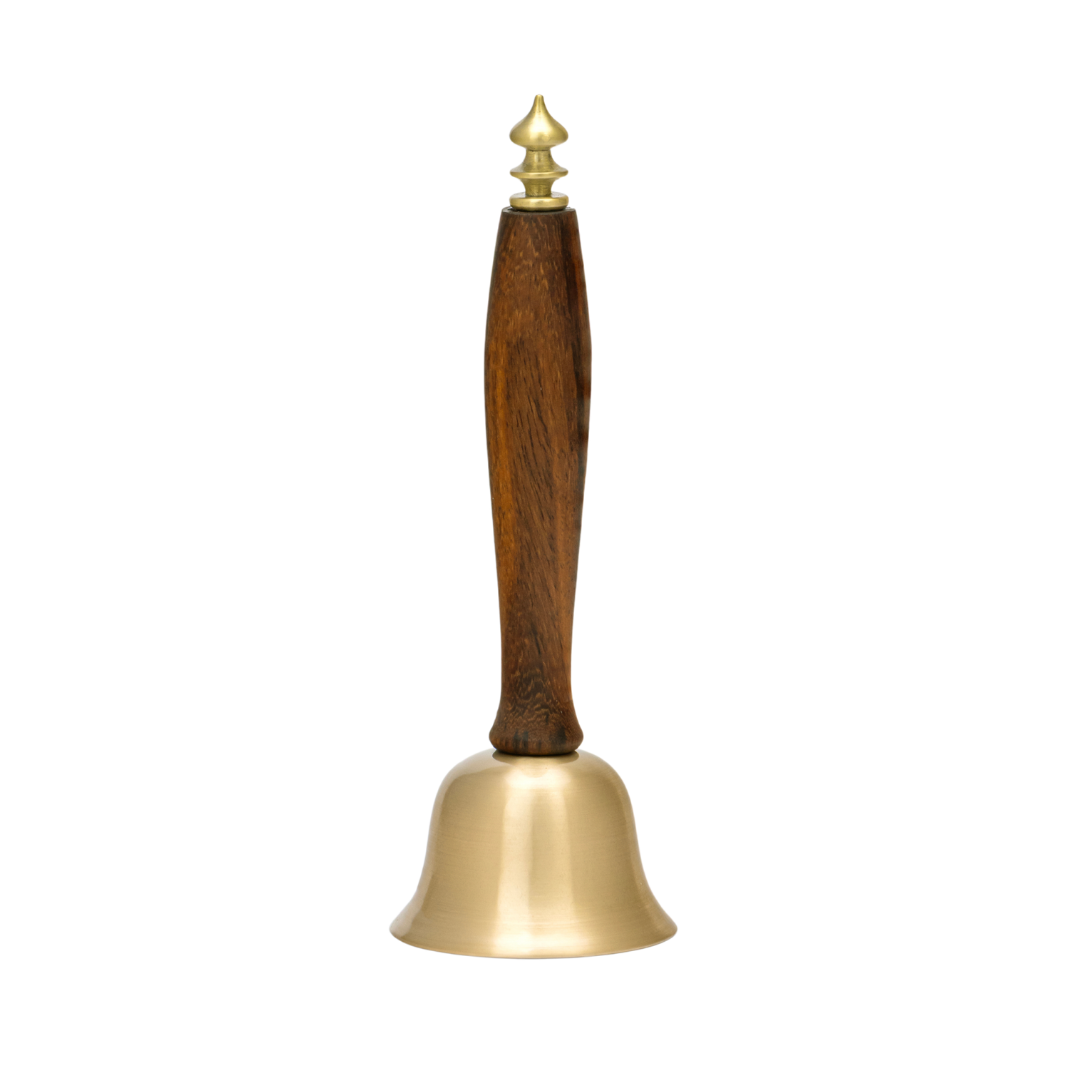 Decorative Brass bell with a wooden handle on a white background